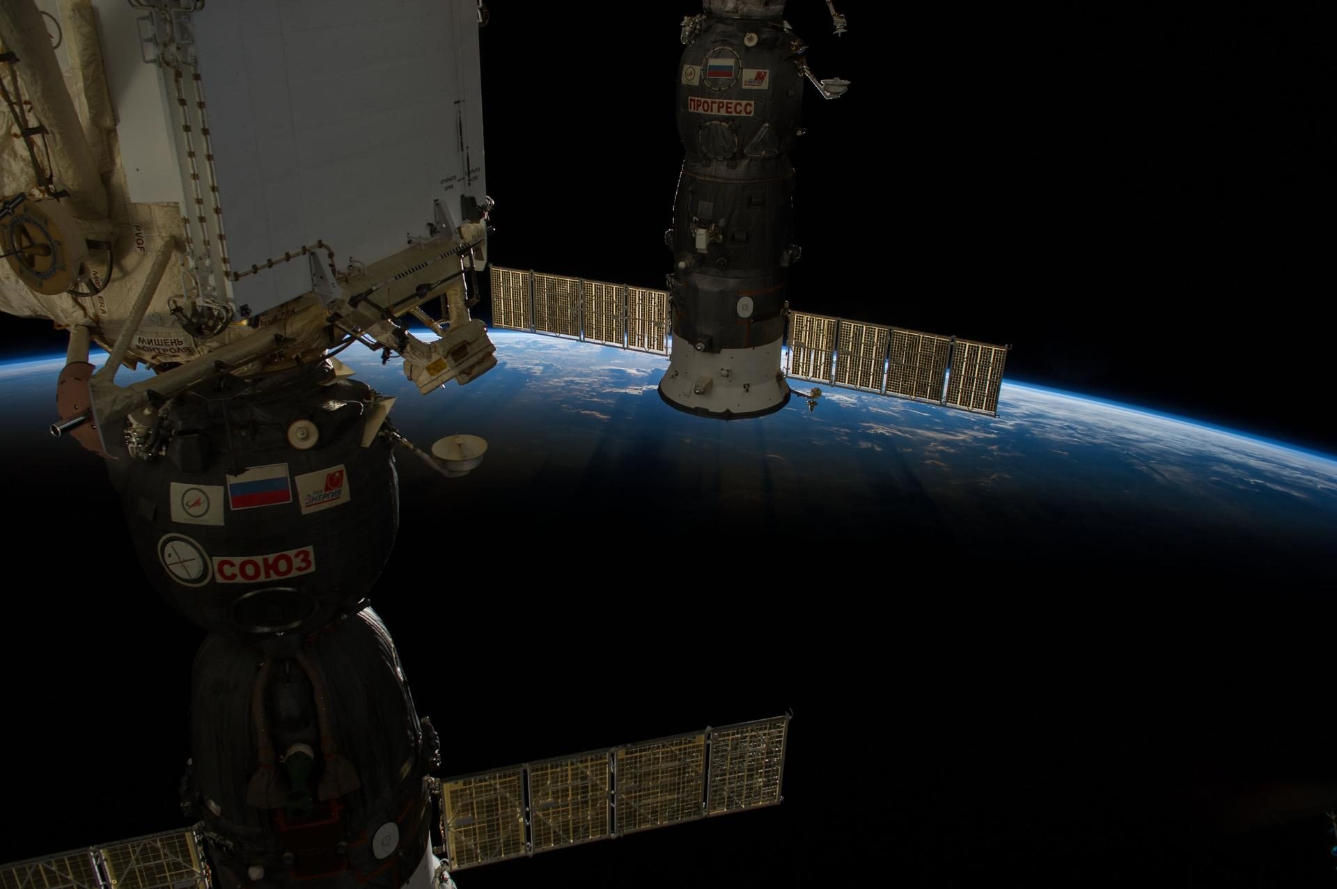 Sunrise over Earth's horizon with a Soyuz spacecraft in the foreground