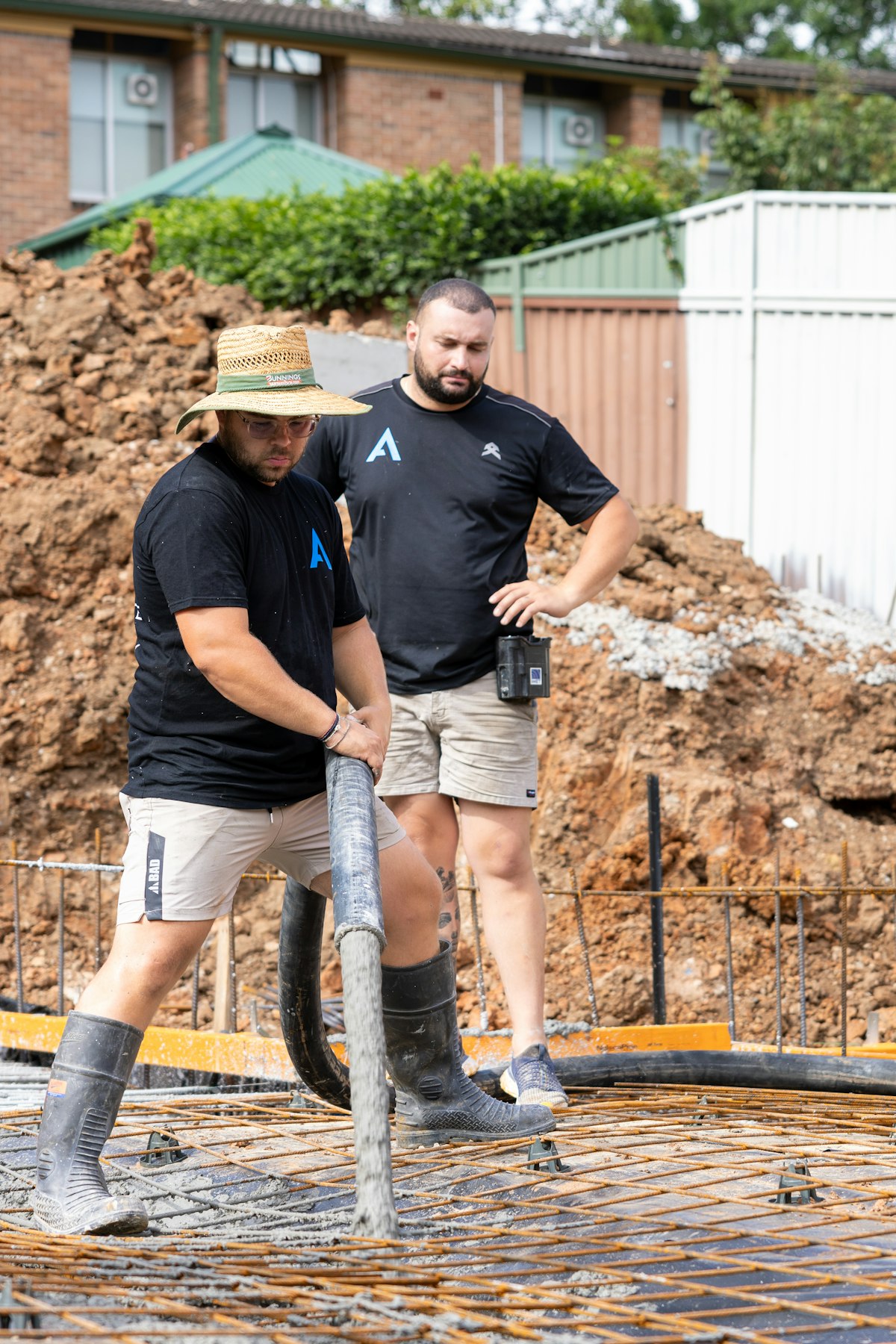 Construction workers leveling a fresh concrete pour